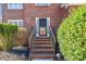 Inviting front entrance with brick steps, iron railings, and lush landscaping at 1039 Ashfern Walk, Woodstock, GA 30189