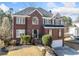 Classic red brick home with manicured front yard and welcoming entrance at 1039 Ashfern Walk, Woodstock, GA 30189