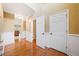 Inviting hallway boasts hardwood floors, wainscoting, and ample natural light at 1039 Ashfern Walk, Woodstock, GA 30189