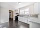 Galley kitchen featuring white cabinetry, granite countertops, and stainless steel appliances at 1039 Ashfern Walk, Woodstock, GA 30189