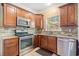 Well-lit kitchen featuring stainless steel appliances, granite countertops, and tile backsplash at 1039 Ashfern Walk, Woodstock, GA 30189