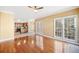 Open-concept living room with hardwood floors, a ceiling fan, and sliding doors to the backyard at 1039 Ashfern Walk, Woodstock, GA 30189