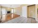 Open living area features hardwood floors, a stone fireplace, and convenient laundry closet at 1039 Ashfern Walk, Woodstock, GA 30189