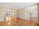 Bright living room with hardwood floors and staircase to the second floor with natural light shining through at 1039 Ashfern Walk, Woodstock, GA 30189