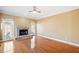 Bright living room featuring hardwood floors and a fireplace with stone surround and hearth at 1039 Ashfern Walk, Woodstock, GA 30189
