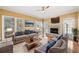 Comfortable living room features hardwood floors, a fireplace, and large windows with natural light at 1039 Ashfern Walk, Woodstock, GA 30189