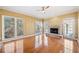 Sun-lit living room boasts hardwood floors, fireplace, and numerous windows for ample natural light at 1039 Ashfern Walk, Woodstock, GA 30189