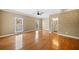 The main bedroom features hardwood floors, a ceiling fan, an ensuite bathroom, and natural light at 1039 Ashfern Walk, Woodstock, GA 30189
