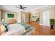 Spacious main bedroom with hardwood floors, a ceiling fan, and an ensuite bathroom at 1039 Ashfern Walk, Woodstock, GA 30189