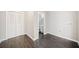 Room featuring new laminate flooring, closet storage, and view of renovated bathroom at 1039 Ashfern Walk, Woodstock, GA 30189