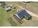 Aerial view of a charming house with surrounding greenery and outbuildings, trampoline and garden at 340 Nail Rd, Mcdonough, GA 30253