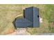 An overhead view reveals the dark roof contrasting with the green landscape, illustrating the property's layout and scale at 340 Nail Rd, Mcdonough, GA 30253