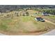 An aerial view shows the house with outbuildings on a large, grassy lot, conveying a sense of space and privacy at 340 Nail Rd, Mcdonough, GA 30253