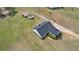 An aerial view shows the house, sheds, and surrounding green property under a sunny, blue sky at 340 Nail Rd, Mcdonough, GA 30253