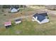 The aerial view showcases the house with outbuildings on a large, grassy lot, conveying a sense of space and privacy at 340 Nail Rd, Mcdonough, GA 30253