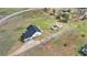 An aerial view shows the house, sheds, and surrounding green property under a sunny, blue sky at 340 Nail Rd, Mcdonough, GA 30253