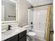 Well-lit bathroom featuring a modern vanity, neutral walls, and a shower-tub combination with stylish curtain at 340 Nail Rd, Mcdonough, GA 30253
