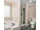 Bathroom featuring a soaking tub, separate glass shower, and stylish black-and-white patterned tile floors at 340 Nail Rd, Mcdonough, GA 30253