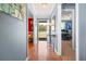 Inviting hallway with hardwood floors, calming colors, and plenty of natural light from the front door at 340 Nail Rd, Mcdonough, GA 30253