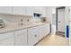 Well-lit kitchen with ample counter space, white cabinets and modern appliances at 340 Nail Rd, Mcdonough, GA 30253