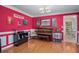 Spacious music room boasts piano, hardwood floors, vibrant decor, and direct access to the breakfast area at 340 Nail Rd, Mcdonough, GA 30253