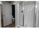 Bright bathroom featuring a glass-enclosed shower and a white door at 3894 Dunaire Dr, Stone Mountain, GA 30083