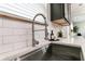 Close-up of the kitchen sink featuring a modern faucet and white quartz countertop at 3894 Dunaire Dr, Stone Mountain, GA 30083