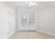 Sunlit bedroom with neutral carpet and double doors to balcony at 4100 Paces Se Walk # 2205, Atlanta, GA 30339