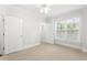 Spacious bedroom with neutral carpet, a closet, and large window at 4100 Paces Se Walk # 2205, Atlanta, GA 30339