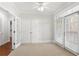 Cozy bedroom with ceiling fan, doors to balcony, and walk-in closet at 4100 Paces Se Walk # 2205, Atlanta, GA 30339
