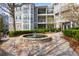 Beautiful condo exterior with stone fountain, manicured landscaping, and stone accents at 4100 Paces Se Walk # 2205, Atlanta, GA 30339