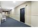 Hallway leading to a door in a carpeted hallway at 4100 Paces Se Walk # 2205, Atlanta, GA 30339