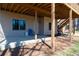 Covered back patio features a concrete surface and outdoor seating, providing a cozy space at 5383 Fawn Meadow Ln, Powder Springs, GA 30127