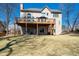 Expansive backyard with a wooden deck, walkout basement, and stairs leading to the lawn, perfect for entertaining at 5383 Fawn Meadow Ln, Powder Springs, GA 30127