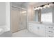 Bathroom with white vanity, shower, and modern light fixture at 5383 Fawn Meadow Ln, Powder Springs, GA 30127