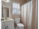 Neutral bathroom featuring a single sink vanity, standard toilet, and shower with curtain at 5383 Fawn Meadow Ln, Powder Springs, GA 30127