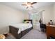 Bright bedroom featuring neutral walls, a window, and a ceiling fan for added comfort at 5383 Fawn Meadow Ln, Powder Springs, GA 30127