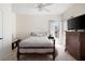 Bright bedroom featuring a bed with grey bedding, window, and dark wood dresser at 5383 Fawn Meadow Ln, Powder Springs, GA 30127