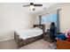 Bedroom with wooden bed frame, desk, ceiling fan, and carpet at 5383 Fawn Meadow Ln, Powder Springs, GA 30127