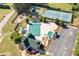 Aerial view of the community pool, tennis courts, playground, and clubhouse showing many outdoor activities at 5383 Fawn Meadow Ln, Powder Springs, GA 30127