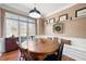 Charming dining room boasting a built-in bench, hardwood floors, and natural light at 5383 Fawn Meadow Ln, Powder Springs, GA 30127