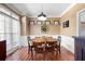 Bright dining area with large windows, hardwood floors, and elegant chair rail at 5383 Fawn Meadow Ln, Powder Springs, GA 30127