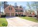 Charming two-story home boasts a brick facade, attached two-car garage, and a meticulously landscaped front yard at 5383 Fawn Meadow Ln, Powder Springs, GA 30127