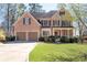 Beautiful two-story home with a brick facade, a well-manicured lawn, and a two-car garage at 5383 Fawn Meadow Ln, Powder Springs, GA 30127