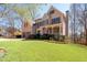 Charming home featuring lush green lawn, mature trees, and beautiful landscaping at 5383 Fawn Meadow Ln, Powder Springs, GA 30127