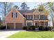 Attractive two-story home boasting a manicured lawn and a welcoming front porch at 5383 Fawn Meadow Ln, Powder Springs, GA 30127