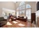 Spacious living room with large windows, an open floor plan, and hardwood floors at 5383 Fawn Meadow Ln, Powder Springs, GA 30127