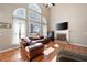 Bright living room with vaulted ceilings, large windows, hardwood floors, and fireplace at 5383 Fawn Meadow Ln, Powder Springs, GA 30127