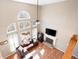 Open living room boasts large windows, fireplace, hardwood floors, and comfortable seating area at 5383 Fawn Meadow Ln, Powder Springs, GA 30127