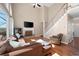 Inviting living room featuring a fireplace, staircase, and large windows with natural light at 5383 Fawn Meadow Ln, Powder Springs, GA 30127